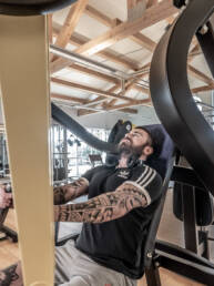 Person trainiert an einer Brustpresse im Fitnesspark Charly zur Stärkung der Brustmuskulatur.